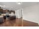 A kitchen displaying dark wood cabinetry, stainless steel appliances, a central island, and hardwood floors at 1108 Renewal Pl, Raleigh, NC 27603