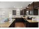 Well-appointed kitchen with granite counters, dark wood cabinetry, and stainless steel appliances at 1108 Renewal Pl, Raleigh, NC 27603