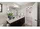 An elegant main bathroom features a vanity, large mirror, and doorway to the main bedroom at 1108 Renewal Pl, Raleigh, NC 27603