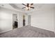 Spacious main bedroom boasts a tray ceiling, fan, carpet flooring, and adjoining bathroom at 1108 Renewal Pl, Raleigh, NC 27603