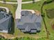 Bird's eye view of a home featuring an expansive roof, driveway and manicured yard next to a pond at 111 Stone Park Dr, Wake Forest, NC 27587