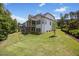 A well-manicured lawn surrounds a modern home with a screened porch and landscaped yard at 111 Stone Park Dr, Wake Forest, NC 27587