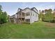 Expansive backyard featuring a modern home with a screened porch and lush green lawn at 111 Stone Park Dr, Wake Forest, NC 27587