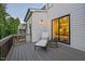Charming deck with outdoor lounge and a view into the dining area at 111 Stone Park Dr, Wake Forest, NC 27587