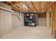 Unfinished basement storage space with shelving, storage bins, and exposed ceiling at 111 Stone Park Dr, Wake Forest, NC 27587