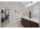 Elegant bathroom features a modern vanity, patterned tile floor, and a spacious walk-in closet at 111 Stone Park Dr, Wake Forest, NC 27587