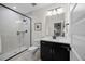 Modern bathroom features a glass shower, dark vanity, and neutral finishes at 111 Stone Park Dr, Wake Forest, NC 27587