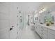Bathroom with a glass shower, a tub, and double vanity with modern fixtures at 111 Stone Park Dr, Wake Forest, NC 27587