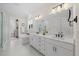 Bathroom with white marble floors, double vanity, a freestanding tub, and a glass-enclosed shower at 111 Stone Park Dr, Wake Forest, NC 27587
