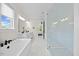 Bathroom featuring a freestanding tub, glass shower, and double vanities with marble countertops at 111 Stone Park Dr, Wake Forest, NC 27587