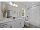 Modern bathroom with dual vanity, white cabinets, and tiled shower/tub at 111 Stone Park Dr, Wake Forest, NC 27587