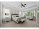 Bright bedroom with a gray upholstered bed, white nightstands, seating, and ample natural light at 111 Stone Park Dr, Wake Forest, NC 27587