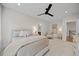 Bedroom offers a calm, neutral palette with a ceiling fan, and doorway to en suite bath at 111 Stone Park Dr, Wake Forest, NC 27587