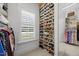 Walk-in closet featuring custom shelving, a window for natural light, and shoe racks at 111 Stone Park Dr, Wake Forest, NC 27587