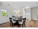 Bright dining area boasts a modern table set, natural light, and access to the outdoors at 111 Stone Park Dr, Wake Forest, NC 27587