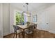 Bright dining room featuring a modern chandelier and an airy view of the outdoors at 111 Stone Park Dr, Wake Forest, NC 27587