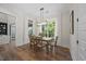 Dining room featuring hardwood floors, stylish light fixture, and view to the exterior patio at 111 Stone Park Dr, Wake Forest, NC 27587
