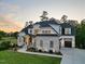 A beautiful two-story home at dusk, showcasing manicured lawn and stone facade at 111 Stone Park Dr, Wake Forest, NC 27587