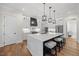 Modern kitchen with a large island, stylish pendant lighting, and stainless steel appliances at 111 Stone Park Dr, Wake Forest, NC 27587