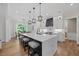 Spacious kitchen with quartz island, stylish lighting, and an open view to the dining area at 111 Stone Park Dr, Wake Forest, NC 27587