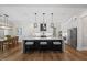 Modern kitchen with a large island, stylish pendant lighting, and stainless steel appliances at 111 Stone Park Dr, Wake Forest, NC 27587