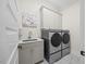 Convenient laundry room with modern washer and dryer, sink, and ample storage space at 111 Stone Park Dr, Wake Forest, NC 27587