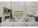 Bright and airy living room with a fireplace and access to outdoor living spaces at 111 Stone Park Dr, Wake Forest, NC 27587