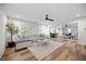 Open-concept living room with hardwood floors, a sectional sofa, and a view into the dining area at 111 Stone Park Dr, Wake Forest, NC 27587