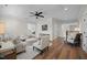 Bright and airy living room featuring hardwood floors, a ceiling fan, and comfortable seating arrangements at 111 Stone Park Dr, Wake Forest, NC 27587