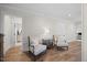 Inviting living room with hardwood floors, comfortable seating, and multiple doorways to other rooms at 111 Stone Park Dr, Wake Forest, NC 27587