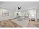 Bright living room with hardwood floors, a neutral sofa, and stylish decor at 111 Stone Park Dr, Wake Forest, NC 27587