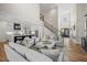 Open-concept living area showcasing a staircase, kitchen, and modern furnishings at 111 Stone Park Dr, Wake Forest, NC 27587