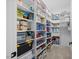 Walk-in pantry with white shelving, neatly organized with various food items and household supplies at 111 Stone Park Dr, Wake Forest, NC 27587
