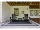 Covered patio with outdoor seating area and views of the backyard at 111 Stone Park Dr, Wake Forest, NC 27587