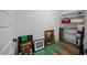 Storage room with shelving, multiple framed pictures, and wood flooring at 111 Stone Park Dr, Wake Forest, NC 27587