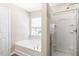 Relaxing bathroom with a soaking tub, a separate shower, and ample natural light at 120 Ryder Cup Cir, Raleigh, NC 27603