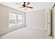 Bright bedroom with neutral carpet, ceiling fan, and a window with natural light at 120 Ryder Cup Cir, Raleigh, NC 27603