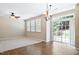Bright dining area with large windows, sliding glass door, chandelier, and tile flooring at 120 Ryder Cup Cir, Raleigh, NC 27603