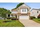 Charming two-story home with stone accents, a well-manicured lawn, and a two-car garage at 120 Ryder Cup Cir, Raleigh, NC 27603