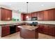 Well-equipped kitchen with rich cabinetry, granite countertops, and stainless-steel appliances at 120 Ryder Cup Cir, Raleigh, NC 27603