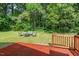 Inviting backyard with a wooden deck and cozy fire pit area, perfect for relaxing at 1207 Grant St, Durham, NC 27701