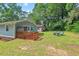 Spacious backyard with a deck, fire pit and chairs, creating a relaxing outdoor oasis at 1207 Grant St, Durham, NC 27701