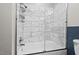 Modern bathroom features a white tiled shower, a shower rack and a glass shower door at 1207 Grant St, Durham, NC 27701