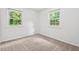 Bright bedroom with large windows offering natural light and exterior views at 1207 Grant St, Durham, NC 27701