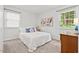 A cozy bedroom featuring neutral walls, carpet, natural light, and simple decor at 1207 Grant St, Durham, NC 27701