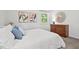 Bright bedroom with two large windows, carpet flooring, and natural wood furniture at 1207 Grant St, Durham, NC 27701