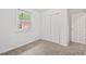 Clean bedroom featuring a closet, large window and neutral paint at 1207 Grant St, Durham, NC 27701