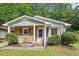 Charming brick home with a cozy front porch, a garden box, and lush landscaping at 1207 Grant St, Durham, NC 27701