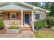 Inviting brick home with a covered porch and a garden box, perfect for curb appeal at 1207 Grant St, Durham, NC 27701