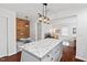 A kitchen with granite countertops, an island with bar seating, and view to the living room at 1207 Grant St, Durham, NC 27701